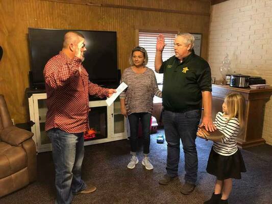 Van Zandt County Precinct 4 Constable Pat Jordan was sworn in by Judge Shinn at his and Melissa Davis’ home with granddaughter Livia holding the bible.